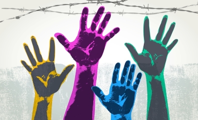 Stock photo of hands reaching in air with a range of colors, with barbed wire overhead