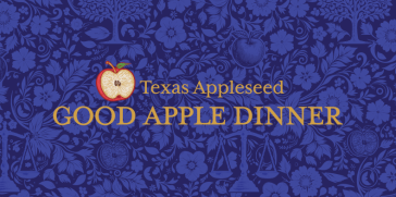 An apple with words "Texas Appleseed" and "Good Apple Dinner" against a blue wallpaper-style background featuring flowers, apples, and the scales of justice