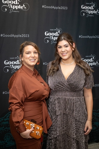 Two guests attend the 2023 Good Apple Dinner.
