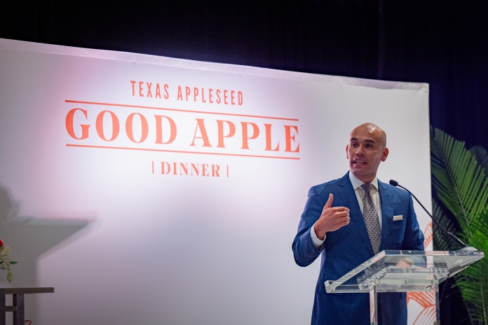 A man talking on stage at the Good Apple Dinner